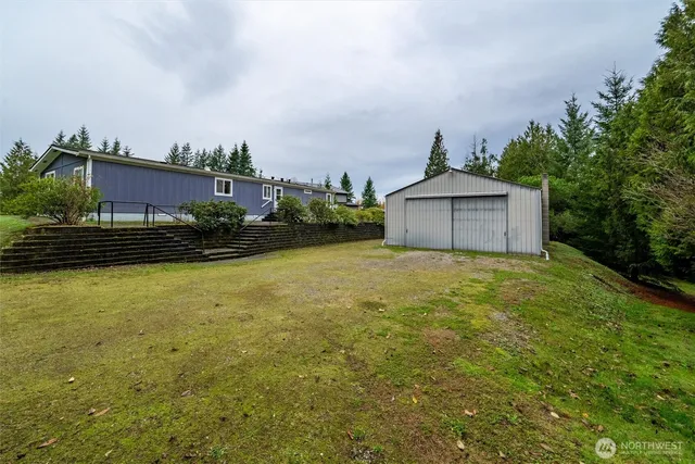 a front view of a house with a garden and yard