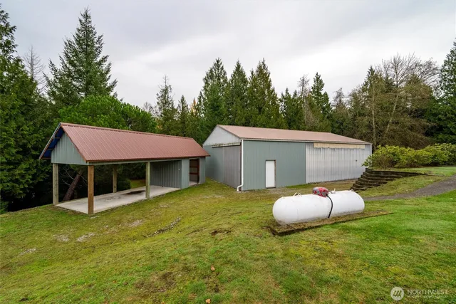 a view of a white house with a backyard