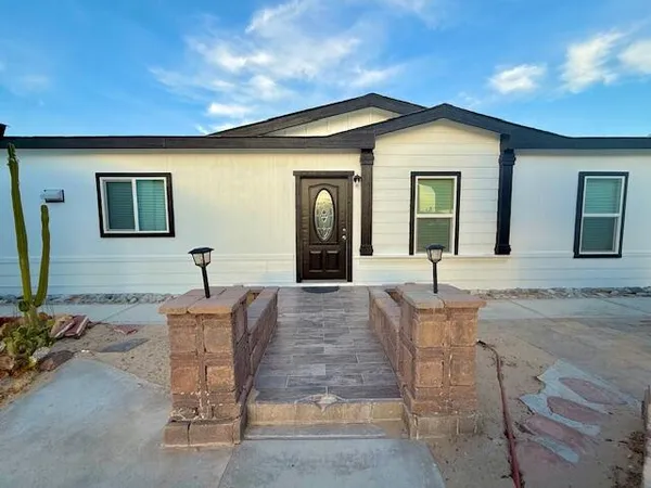 a view of a house with backyard and porch