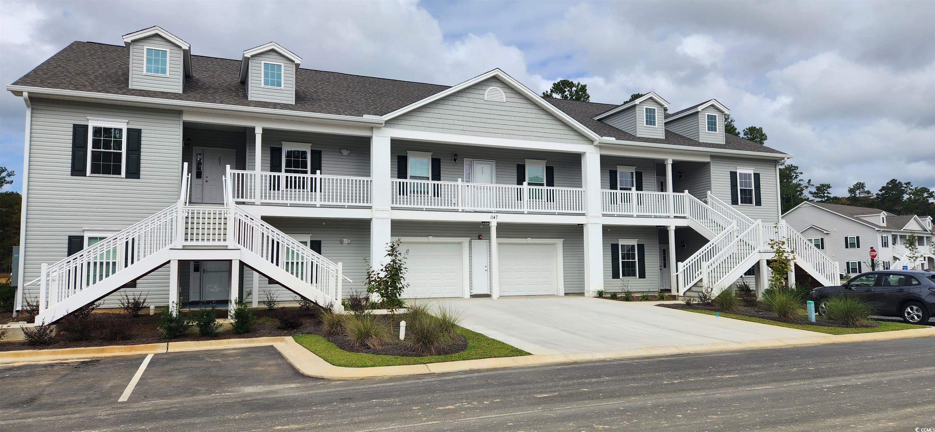 1411 Gooseneck Place, Unit 103 Murrells Inlet, SC 29576 - Photo 1 of 35 View of front of house with a garage and a porch