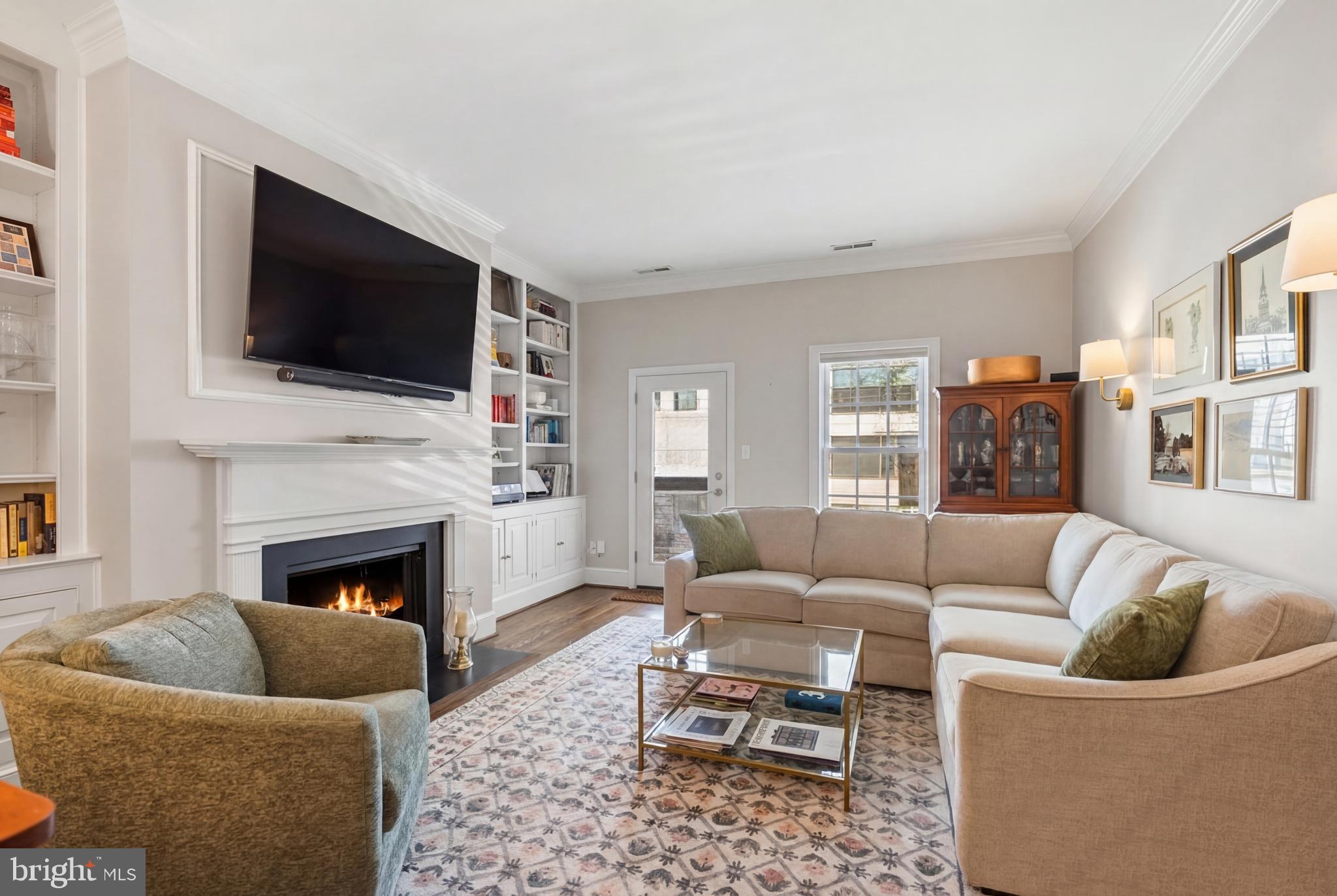 2011 Hillyer Place Northwest Washington, DC 20009 - Photo 5 of 21 a living room with furniture a flat screen tv and a fireplace