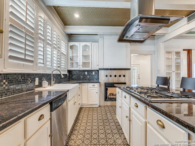 a kitchen with stainless steel appliances granite countertop a stove and a sink