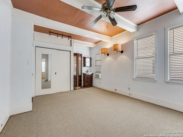 a view of a livingroom with a ceiling fan and window