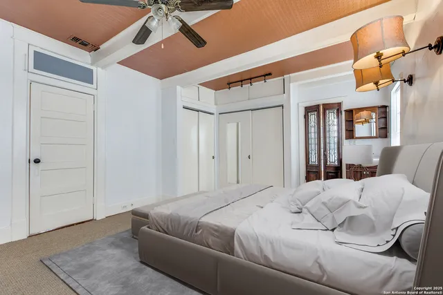 a bedroom with a bed and a chandelier