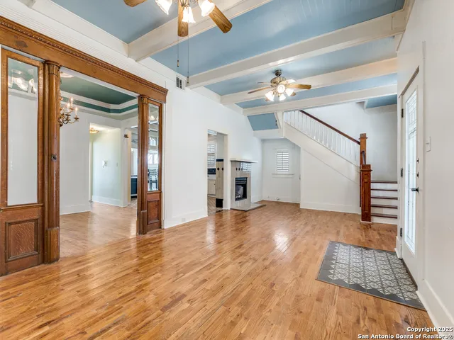 a view of empty room with wooden floor