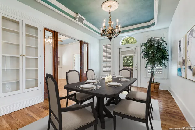 a view of a dining room with furniture wooden floor and chandelier