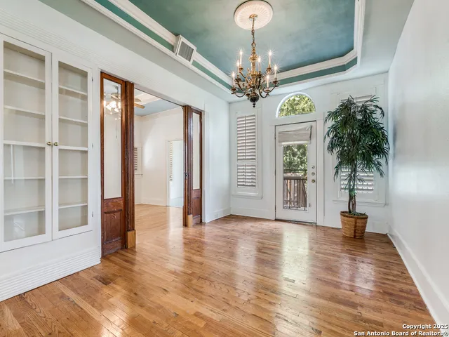 a view of an entryway with wooden floor and door