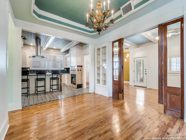 a view of a living room kitchen with stainless steel appliances refrigerator