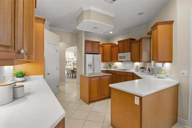 a living room with furniture a rug and a lamp