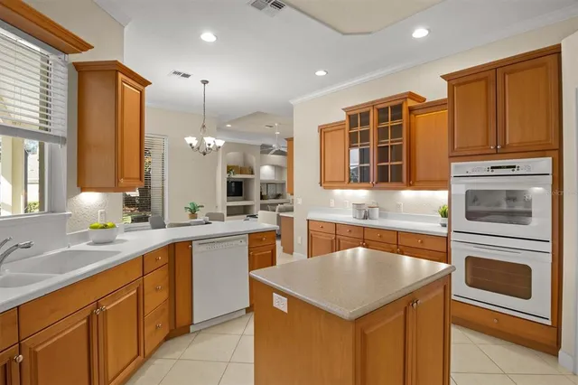 a kitchen with granite countertop stainless steel appliances and wooden cabinets