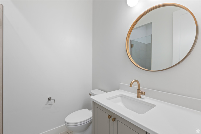 1192 East Corral Way Washington, UT 84780 - Photo 37 of 81 Bathroom featuring a vanity with a white countertop, an undermount sink, and a brass-finish faucet