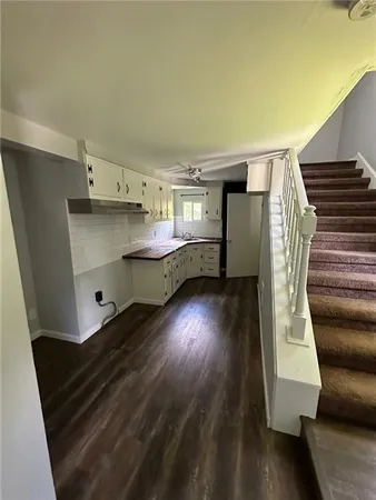 a room with wooden floors and stairs