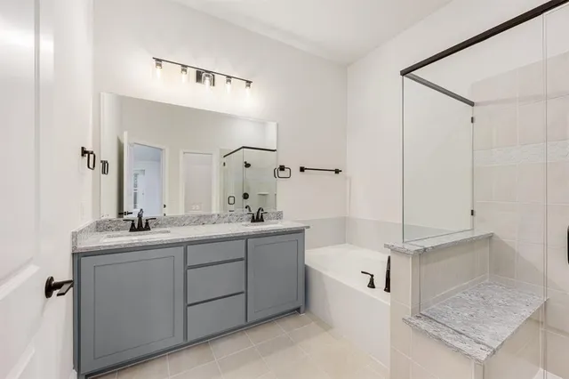 a bathroom with a double vanity sink mirror and