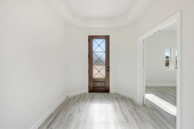 an empty room with closet and windows