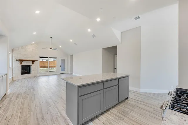 a kitchen with stainless steel appliances a refrigerator and a stove top oven