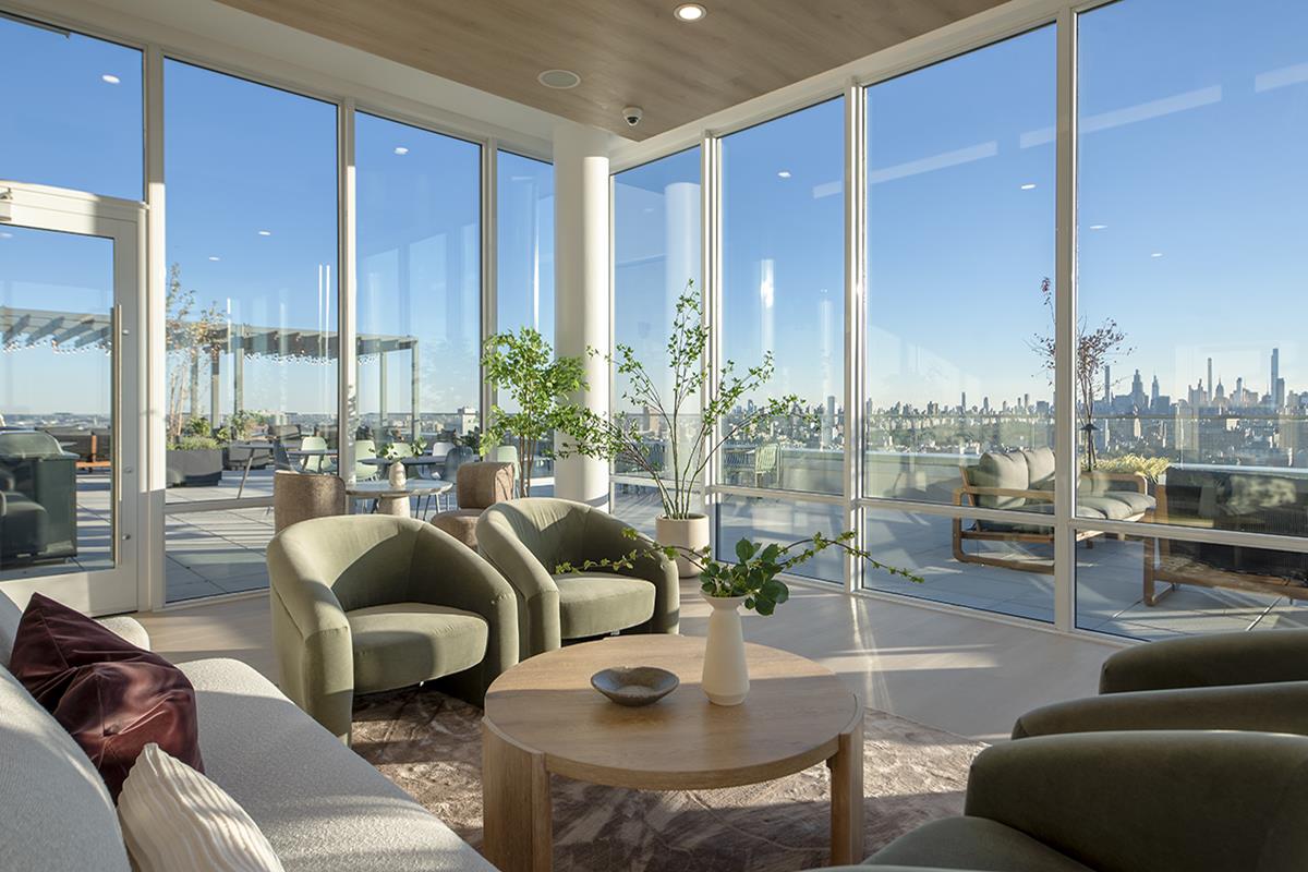 1440 Amsterdam Avenue, Unit 1707 Manhattan, NY 10027 - Photo 18 of 22 a living room with furniture and a large window