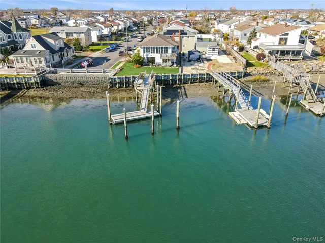 an aerial view of residential houses with outdoor space and swimming pool