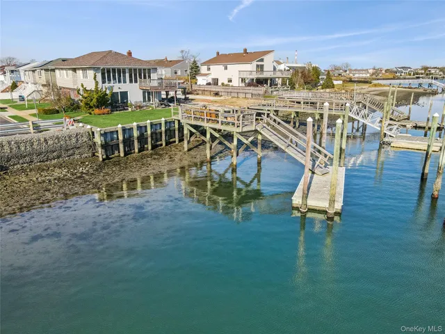 an aerial view of a house with a table chairs