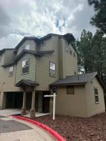 a front view of a house with garage