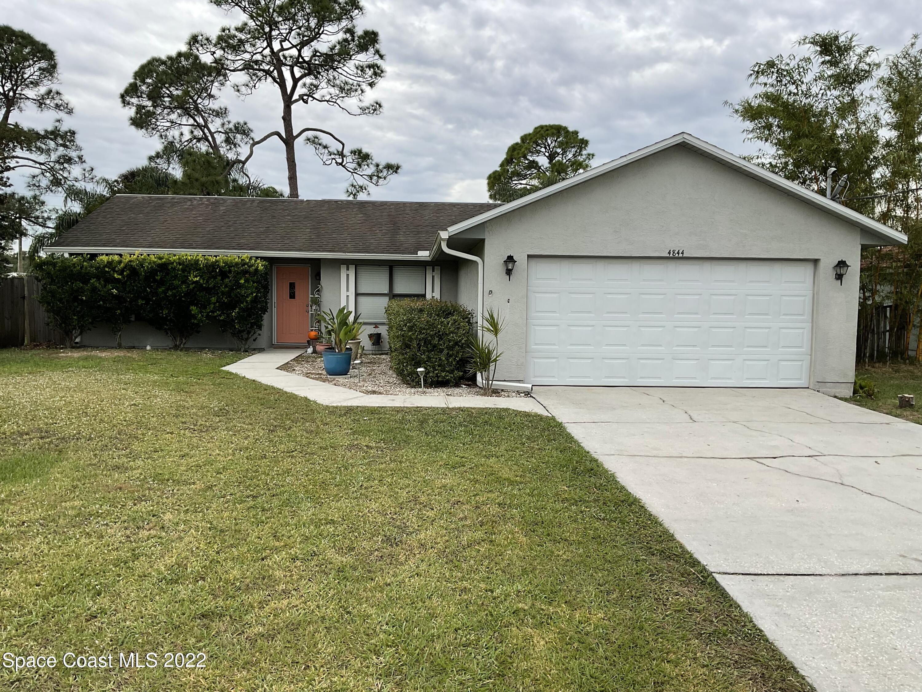 4844 Bridge Road Cocoa, FL 32927 - Photo 1 of 22 a front view of a house with a garden