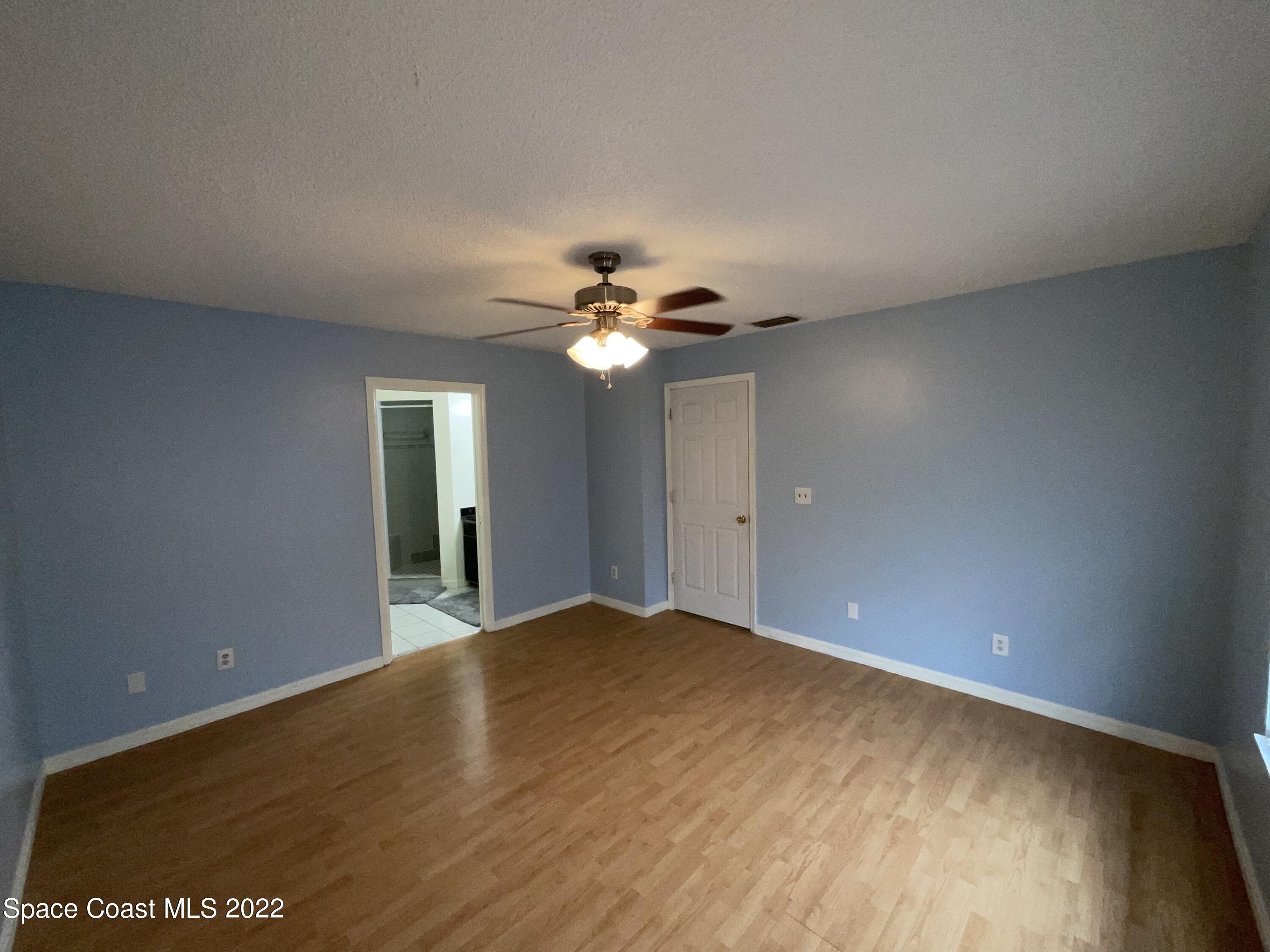 4844 Bridge Road Cocoa, FL 32927 - Photo 11 of 22 a view of a big room with wooden floor and windows