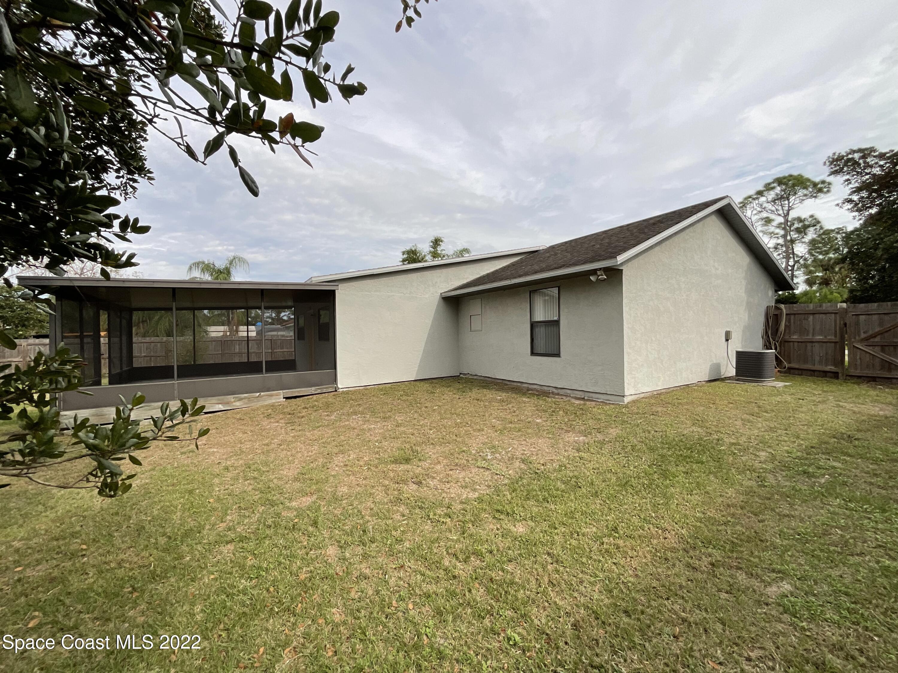4844 Bridge Road Cocoa, FL 32927 - Photo 12 of 22 a view of a house with a yard and garage
