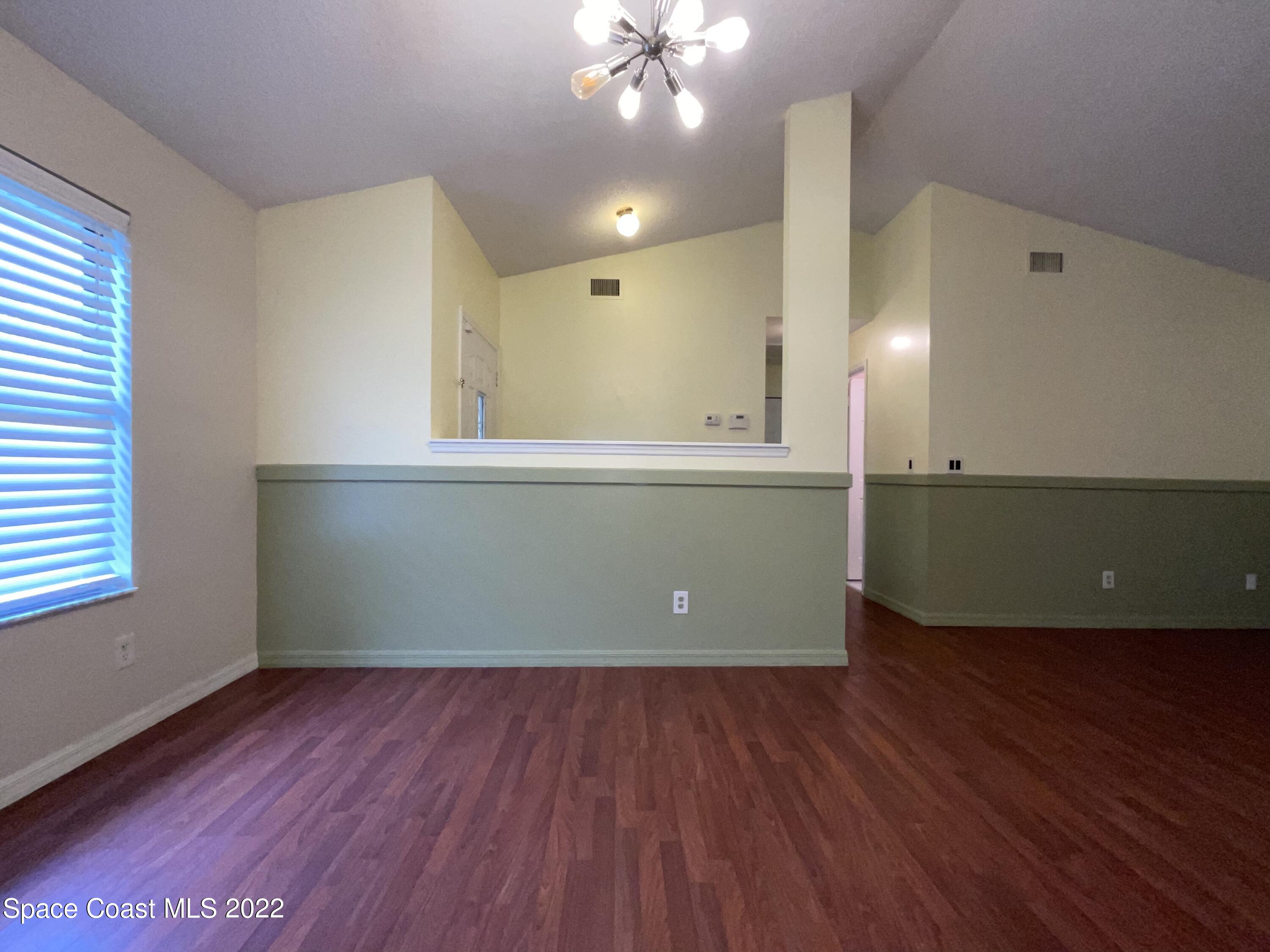 4844 Bridge Road Cocoa, FL 32927 - Photo 15 of 22 a view of a room with wooden floor and cabinets