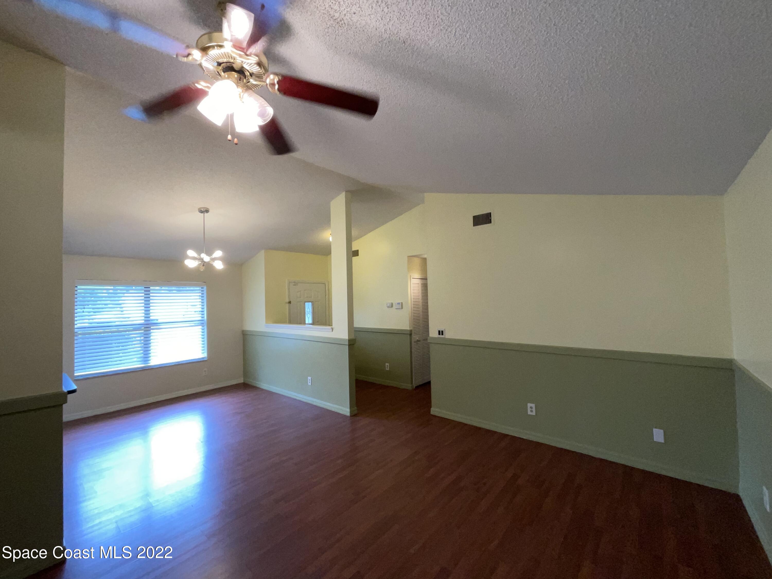 4844 Bridge Road Cocoa, FL 32927 - Photo 6 of 22 wooden floor in an empty room with a window
