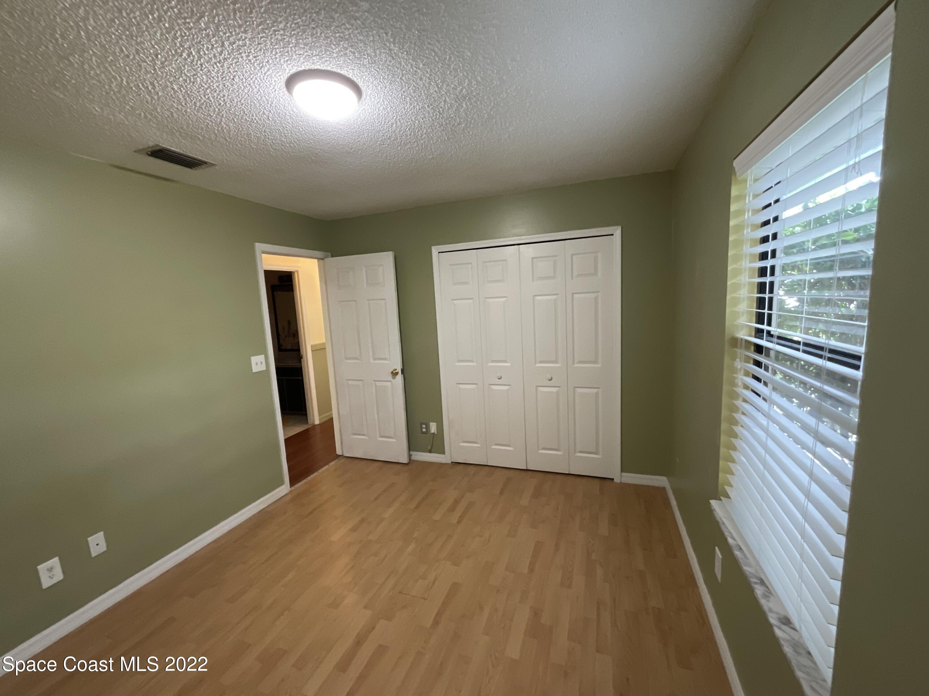 4844 Bridge Road Cocoa, FL 32927 - Photo 7 of 22 an empty room with closet and mirror