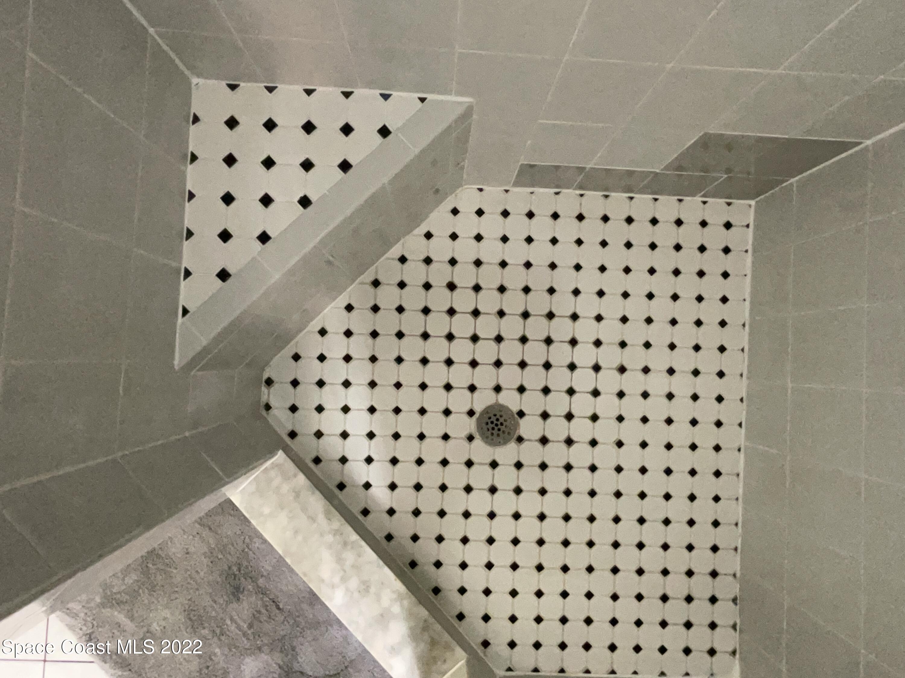 4844 Bridge Road Cocoa, FL 32927 - Photo 8 of 22 a bathroom with a black and white checkered floor