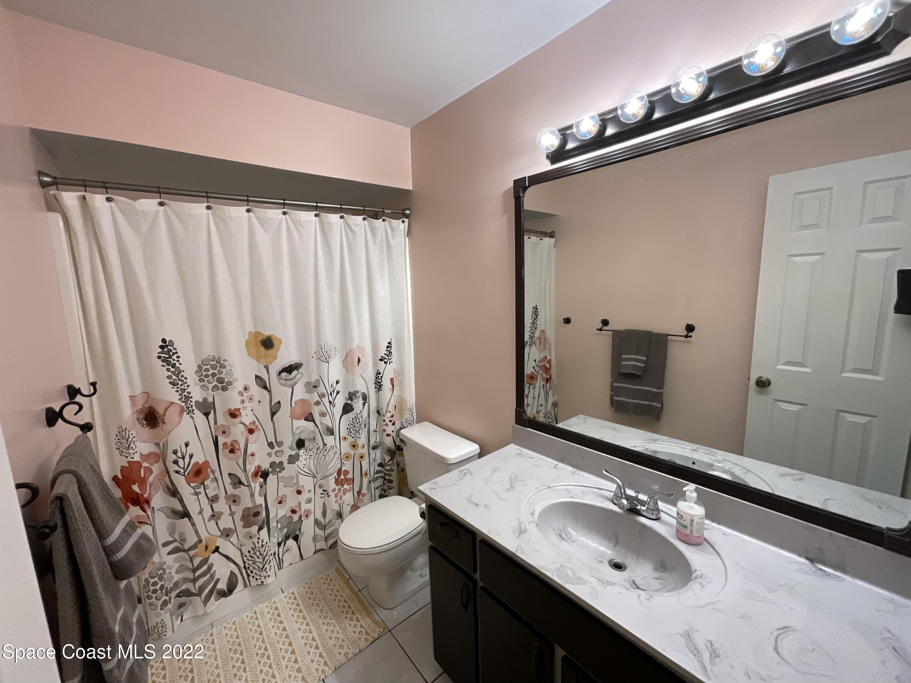 4844 Bridge Road Cocoa, FL 32927 - Photo 9 of 22 a bathroom with a granite countertop sink toilet and shower
