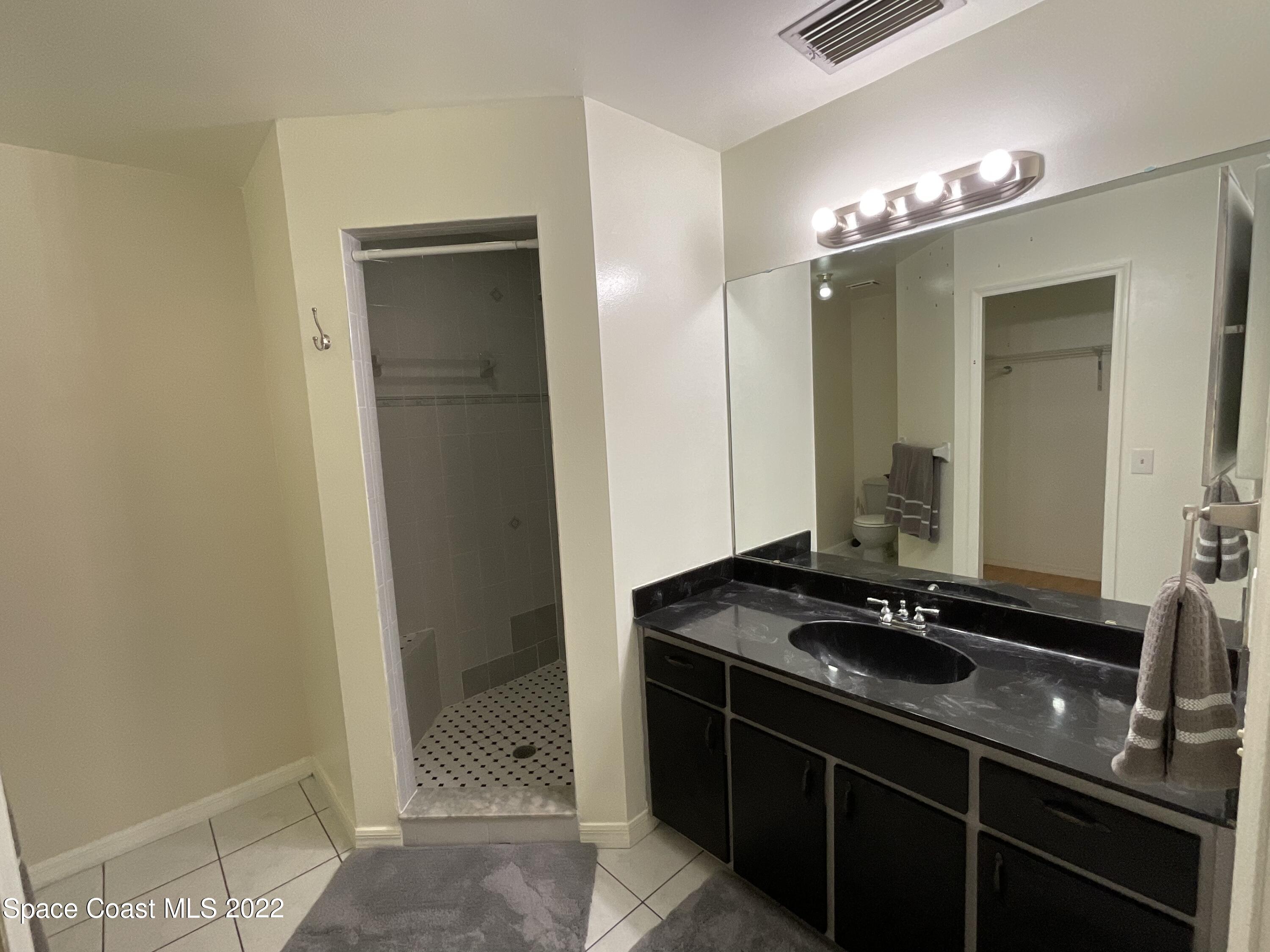 4844 Bridge Road Cocoa, FL 32927 - Photo 10 of 22 a bathroom with a sink and a mirror