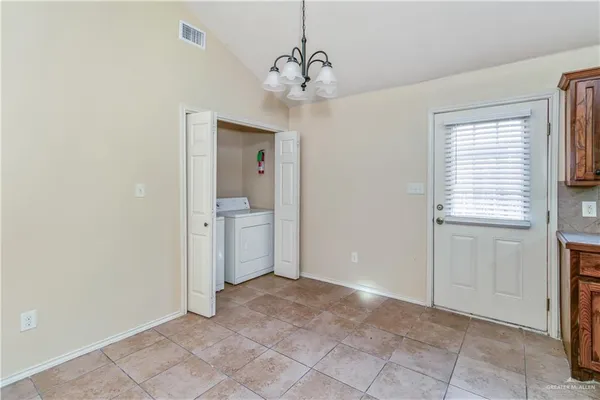a view of a room with a chandelier fan and windows