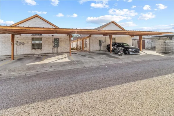 a front view of a house with a garden and parking space
