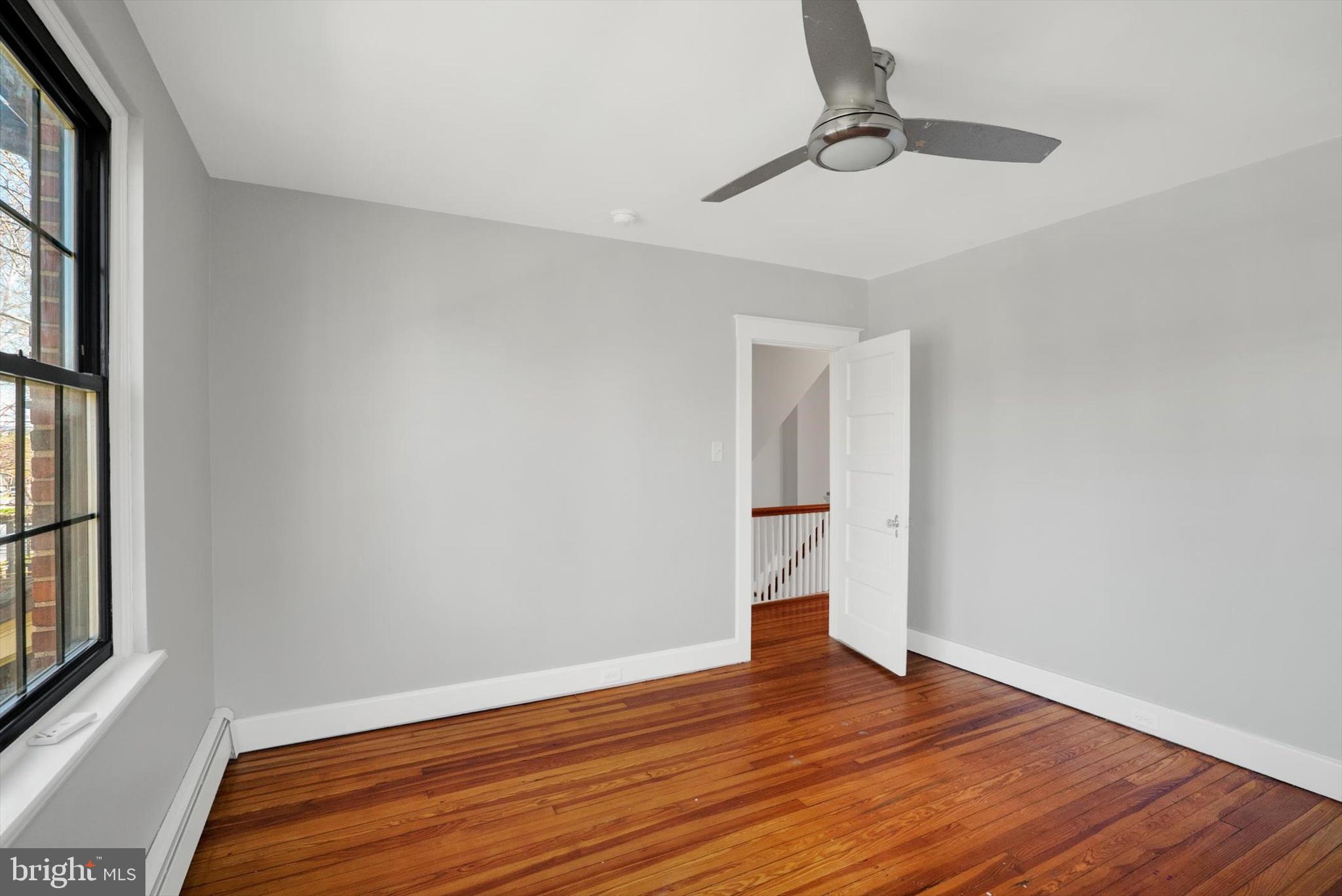 315 Sunset Road Reading, PA 19611 - Photo 11 of 20 a view of empty room with wooden floor and fan