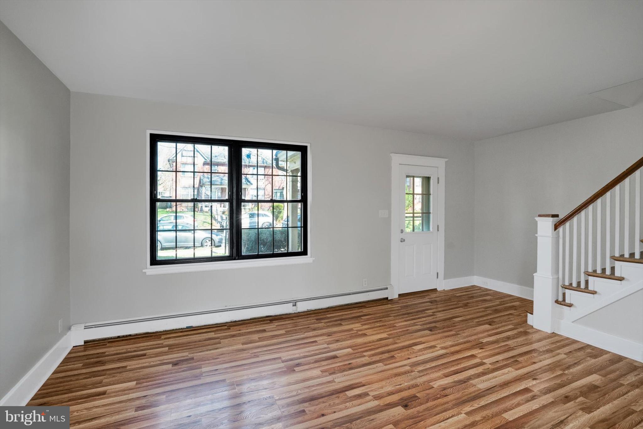 315 Sunset Road Reading, PA 19611 - Photo 2 of 20 a view of an empty room with wooden floor and a window