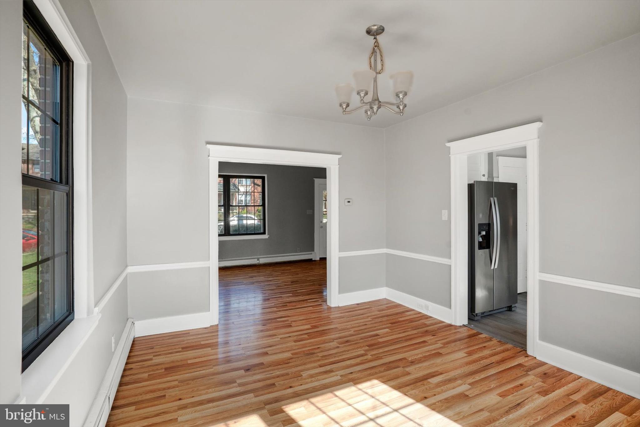 315 Sunset Road Reading, PA 19611 - Photo 6 of 20 a view of an empty room with window and wooden floor