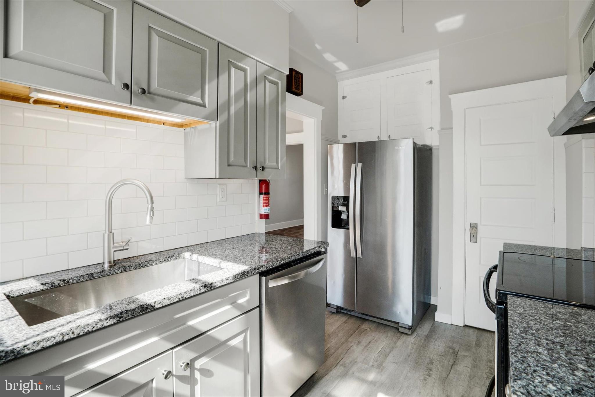 315 Sunset Road Reading, PA 19611 - Photo 8 of 20 a kitchen with granite countertop a refrigerator and a sink