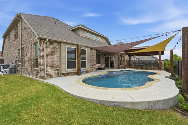 a view of a house with pool and porch