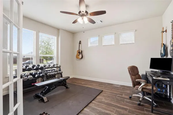a view of a workspace with furniture and a window