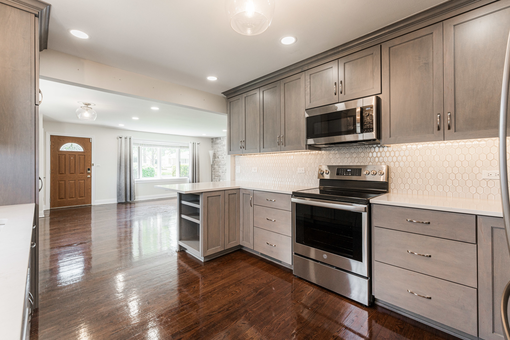 239 Nordic Road Bloomingdale, IL 60108 - Photo 11 of 40 a kitchen with stainless steel appliances granite countertop a stove a sink and a microwave