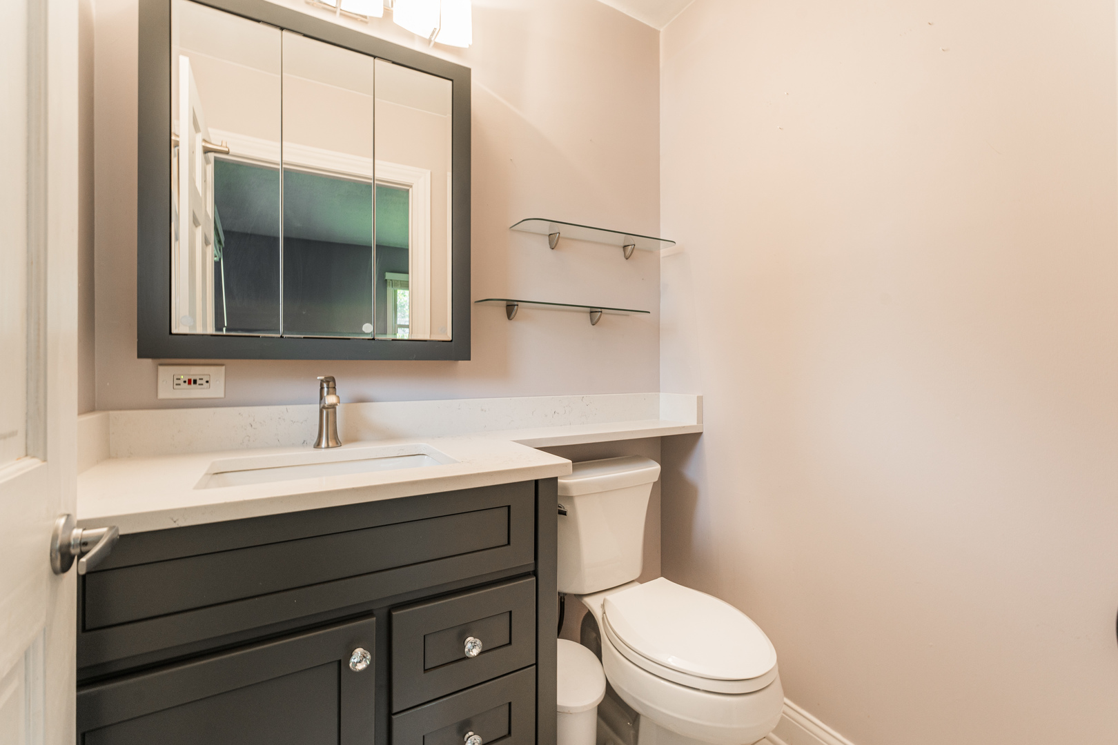 239 Nordic Road Bloomingdale, IL 60108 - Photo 15 of 40 a bathroom with a toilet a sink a vanity and mirror
