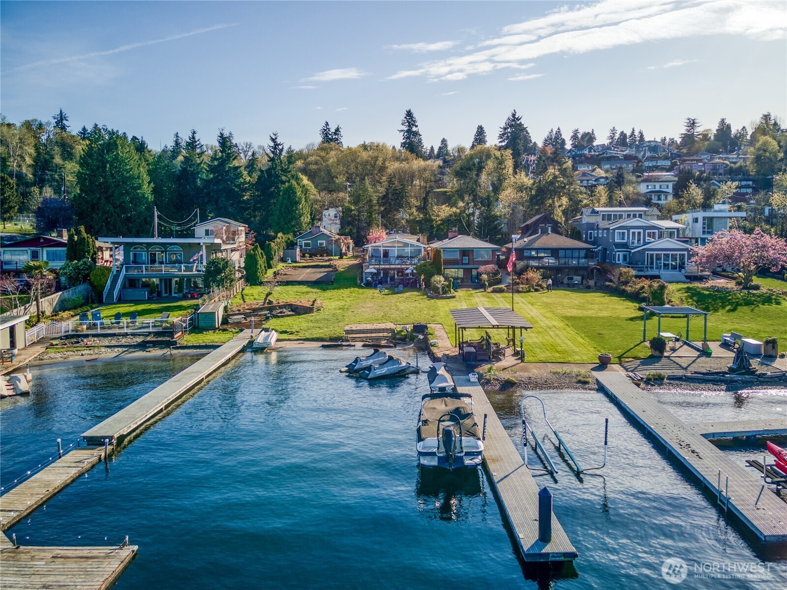an aerial view of a swimming pool with seating area and hardwood floor