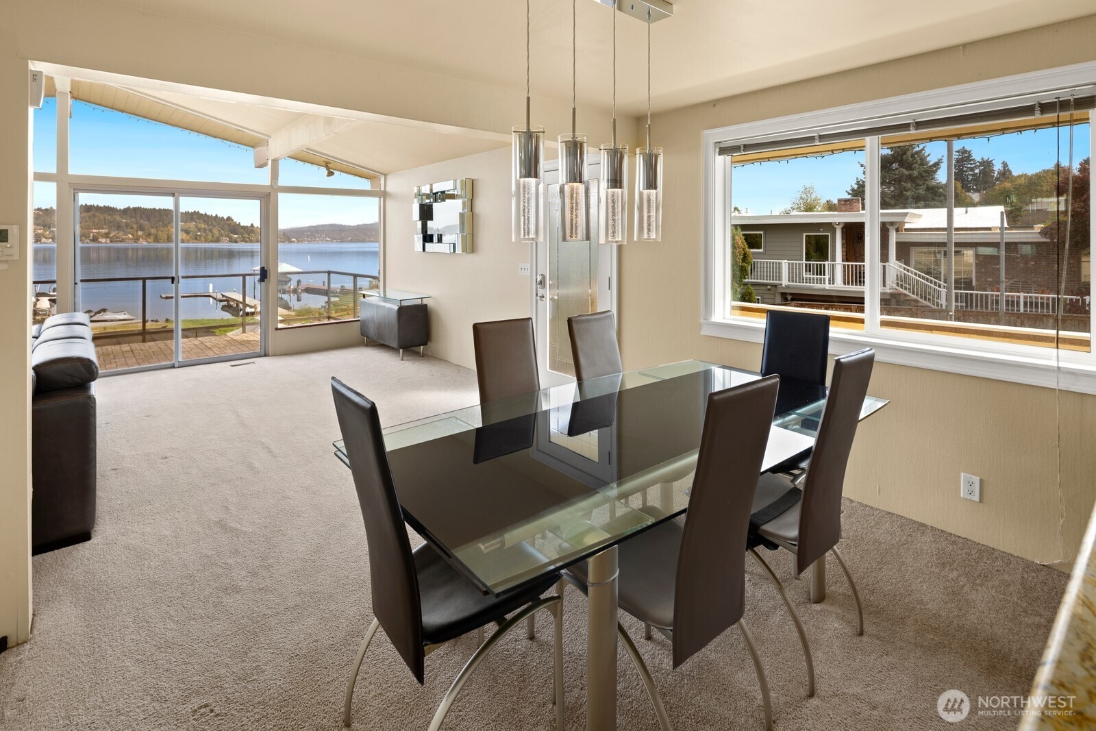10008 Rainier Avenue South Seattle, WA 98178 - Photo 19 of 40 a view of a dining room with furniture large windows and wooden floor