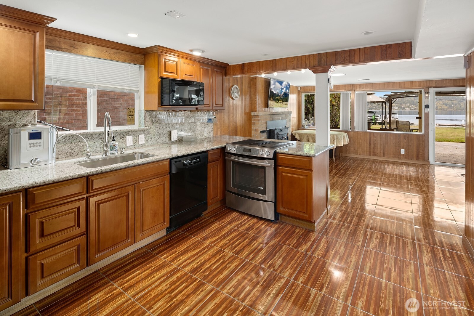 10008 Rainier Avenue South Seattle, WA 98178 - Photo 25 of 40 a kitchen with stainless steel appliances granite countertop wooden floors and sink