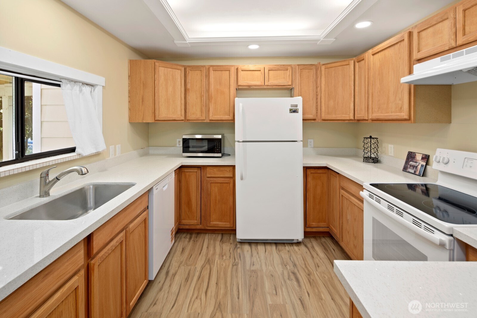 10008 Rainier Avenue South Seattle, WA 98178 - Photo 34 of 40 a kitchen with a sink a refrigerator a window and cabinets