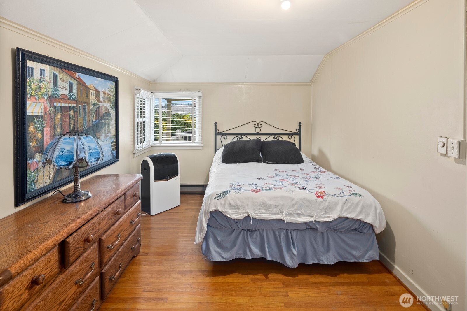 10008 Rainier Avenue South Seattle, WA 98178 - Photo 38 of 40 a bedroom with a bed and wooden floor