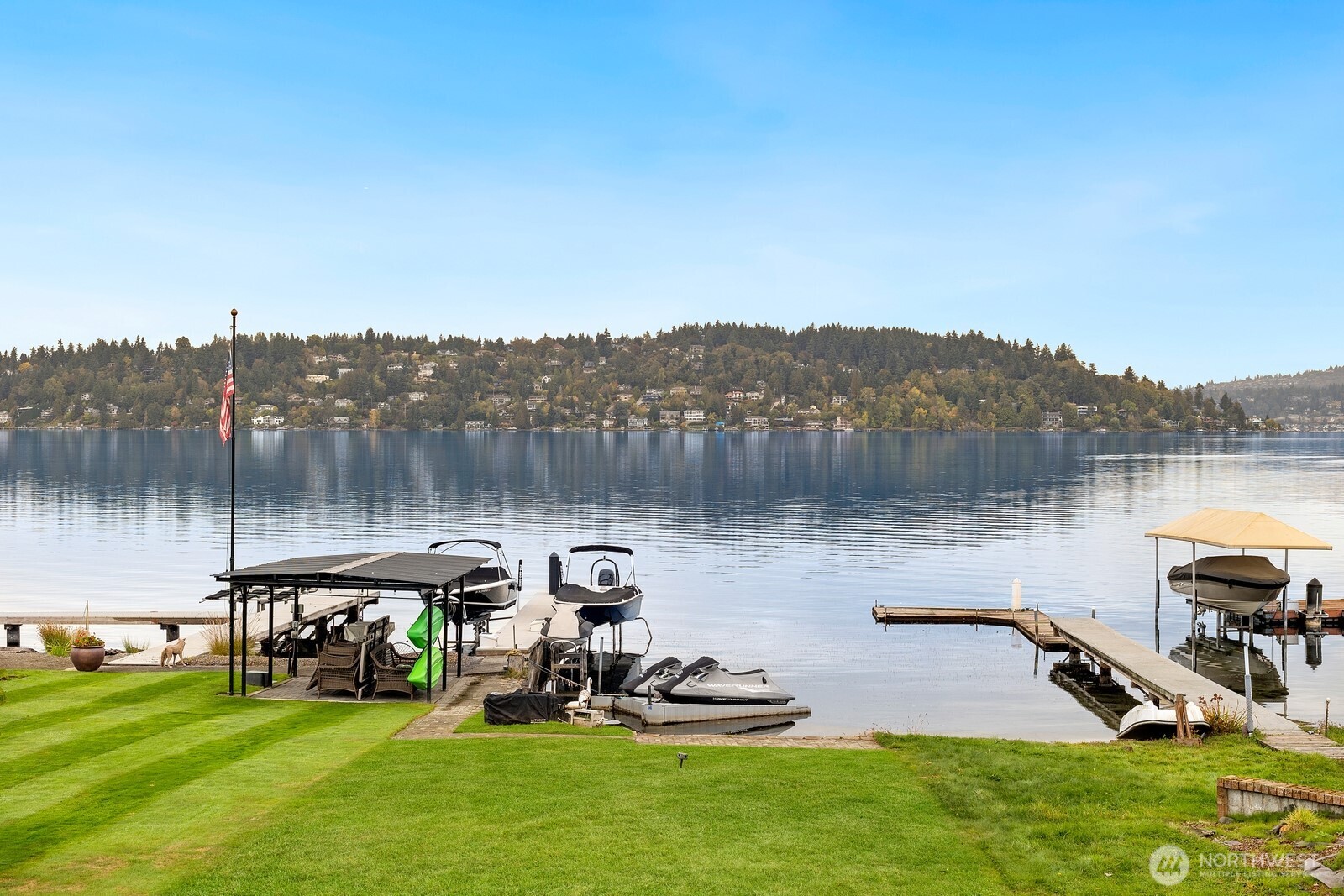 10008 Rainier Avenue South Seattle, WA 98178 - Photo 4 of 40 a view of a lake with a yard and a wooden fence