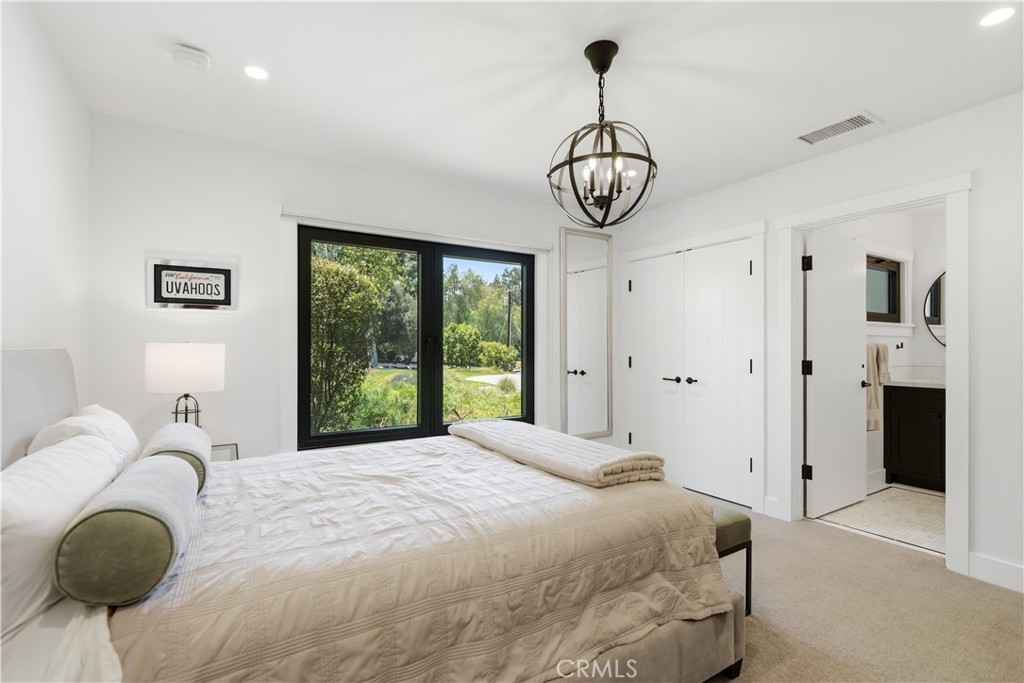 24884 Jim Bridger Road Hidden Hills, CA 91302 - Photo 22 of 31 a bedroom with a bed and window