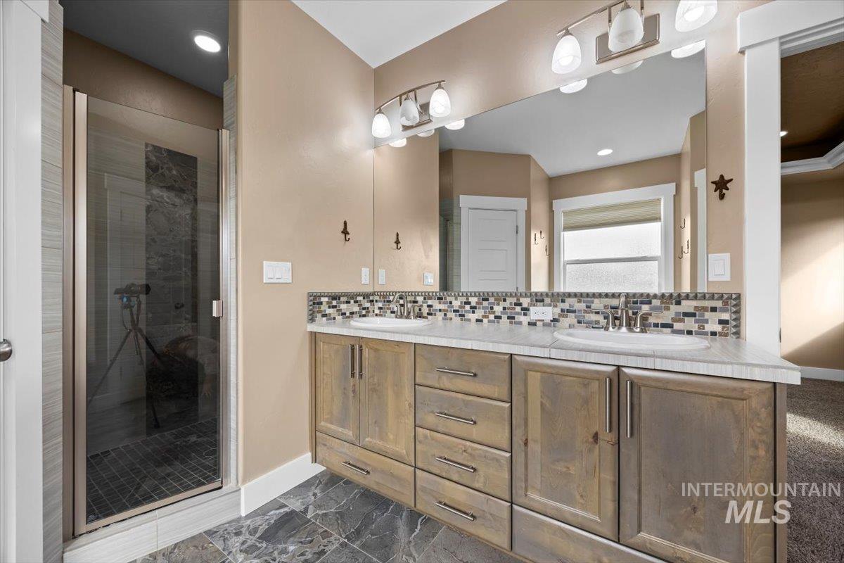 13557 Signorello Street Caldwell, ID 83607 - Photo 14 of 30 Full bathroom featuring a stall shower, tasteful backsplash, double vanity, and recessed lighting